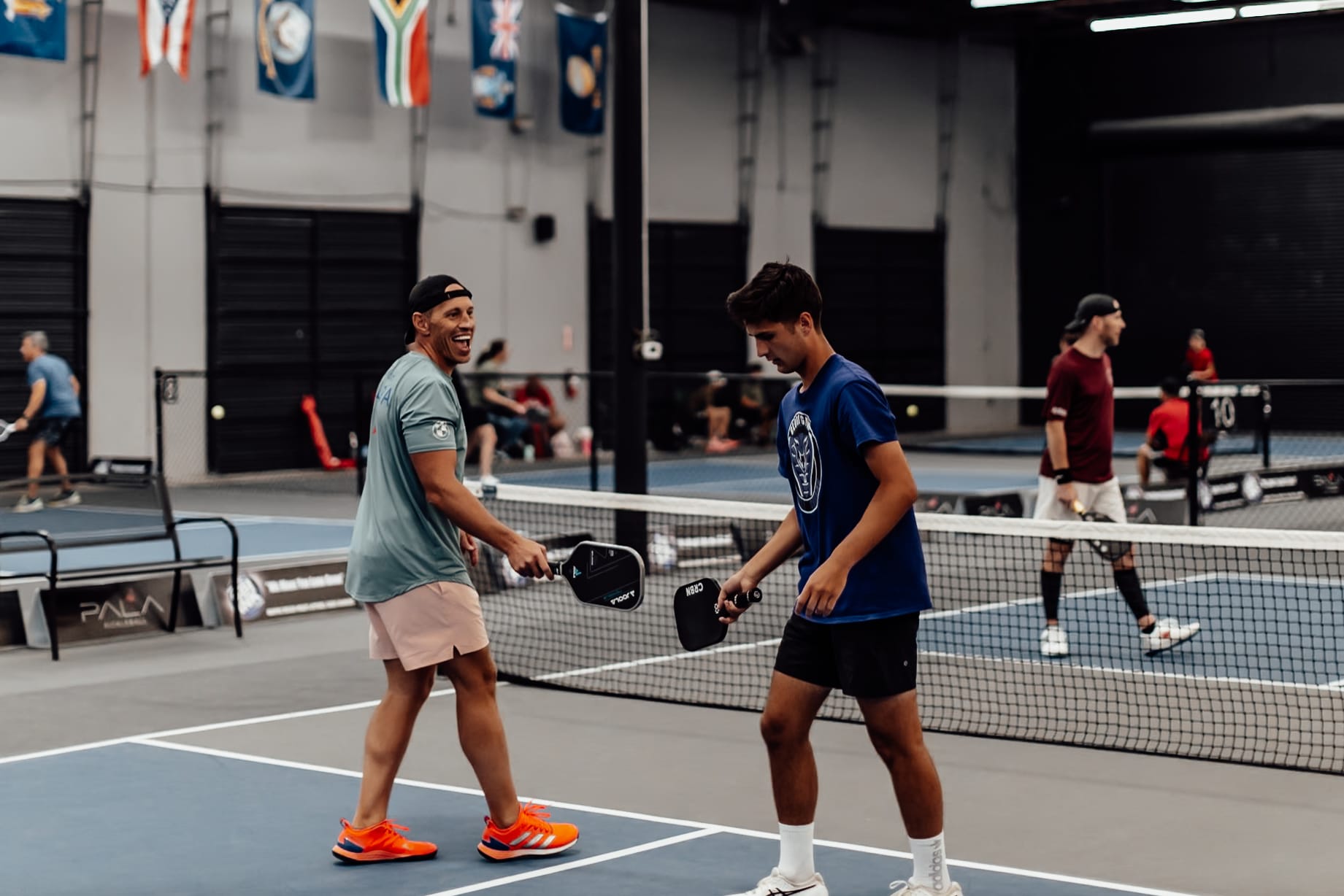 Pickleball players tapping paddles after a point